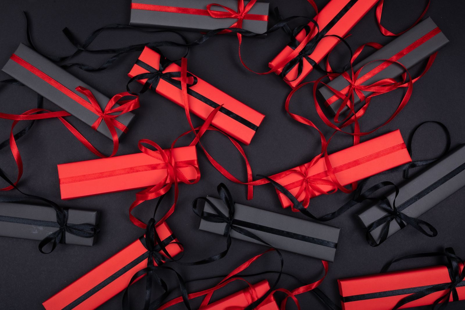 Red gift boxes with black ribbons arranged in pairs, like BOGO cruise deals